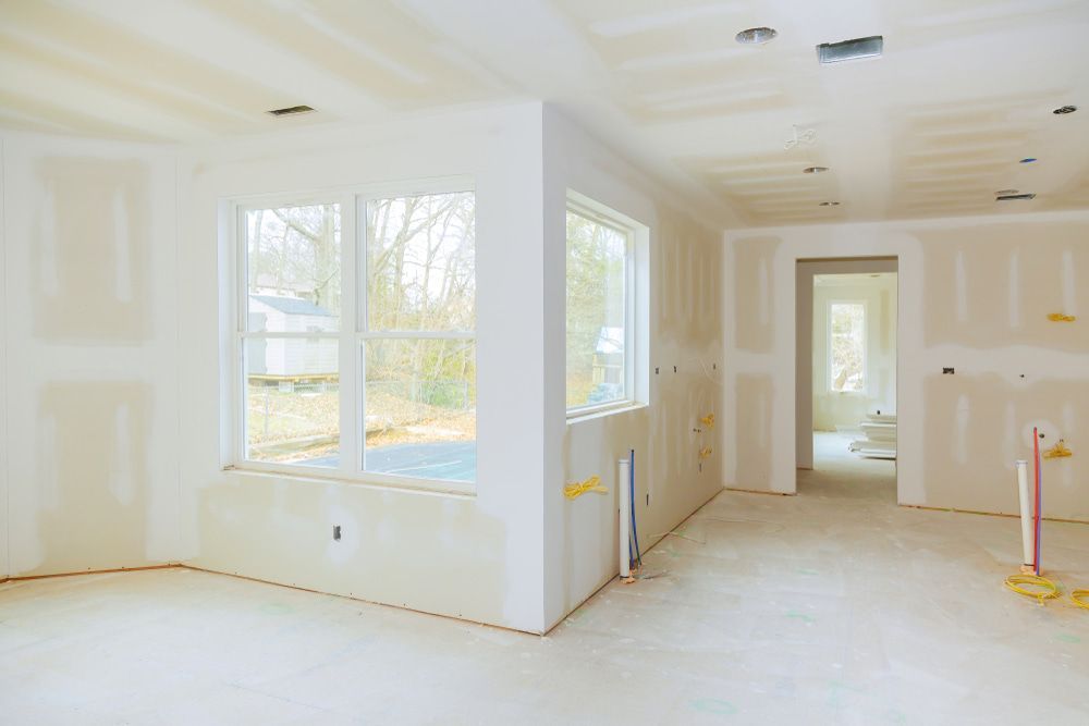 An Empty Room With Drywall And Windows In A House Under Construction — Strait Edge Painting In Tweed Heads South, NSW