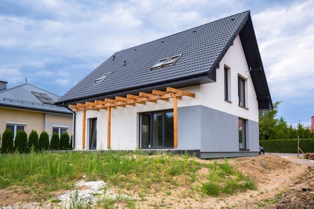 A White House With A Black Roof Is Sitting On Top Of A Dirt Hill — Strait Edge Painting In Tweed Heads South, NSW