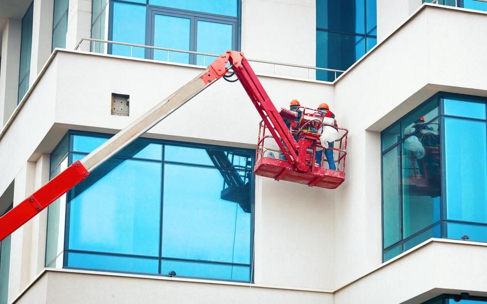 A Group Of People Are Painting The Wall Of A Building — Strait Edge Painting In Gold Coast, NSW