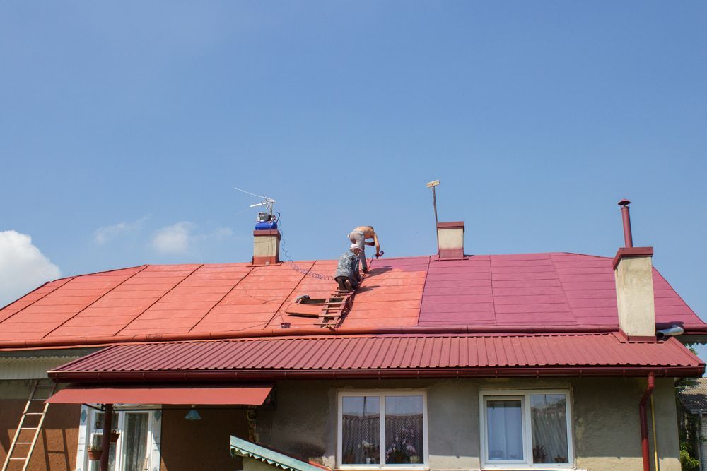 Two Men Are Painting The Roof Of A House — Strait Edge Painting In Tweed Heads South, NSW