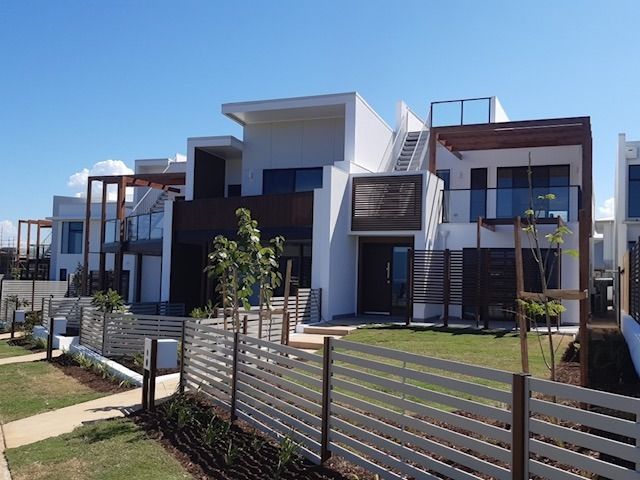 A Row Of Houses With A Fence In Front Of Them — Strait Edge Painting In Tweed Heads South, NSW