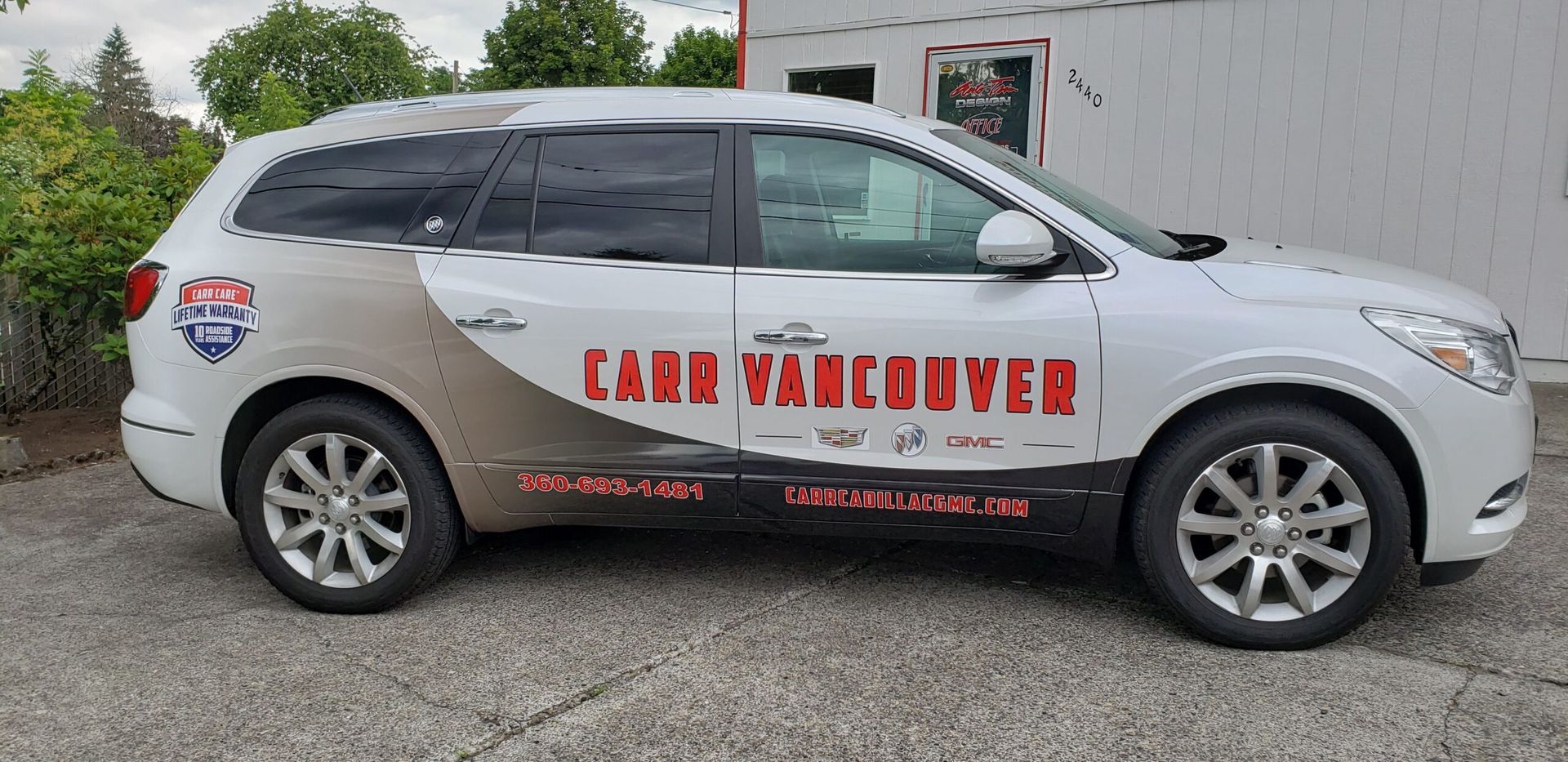 White SUV with red “EAGLE GUTTER” lettering parked outside a building