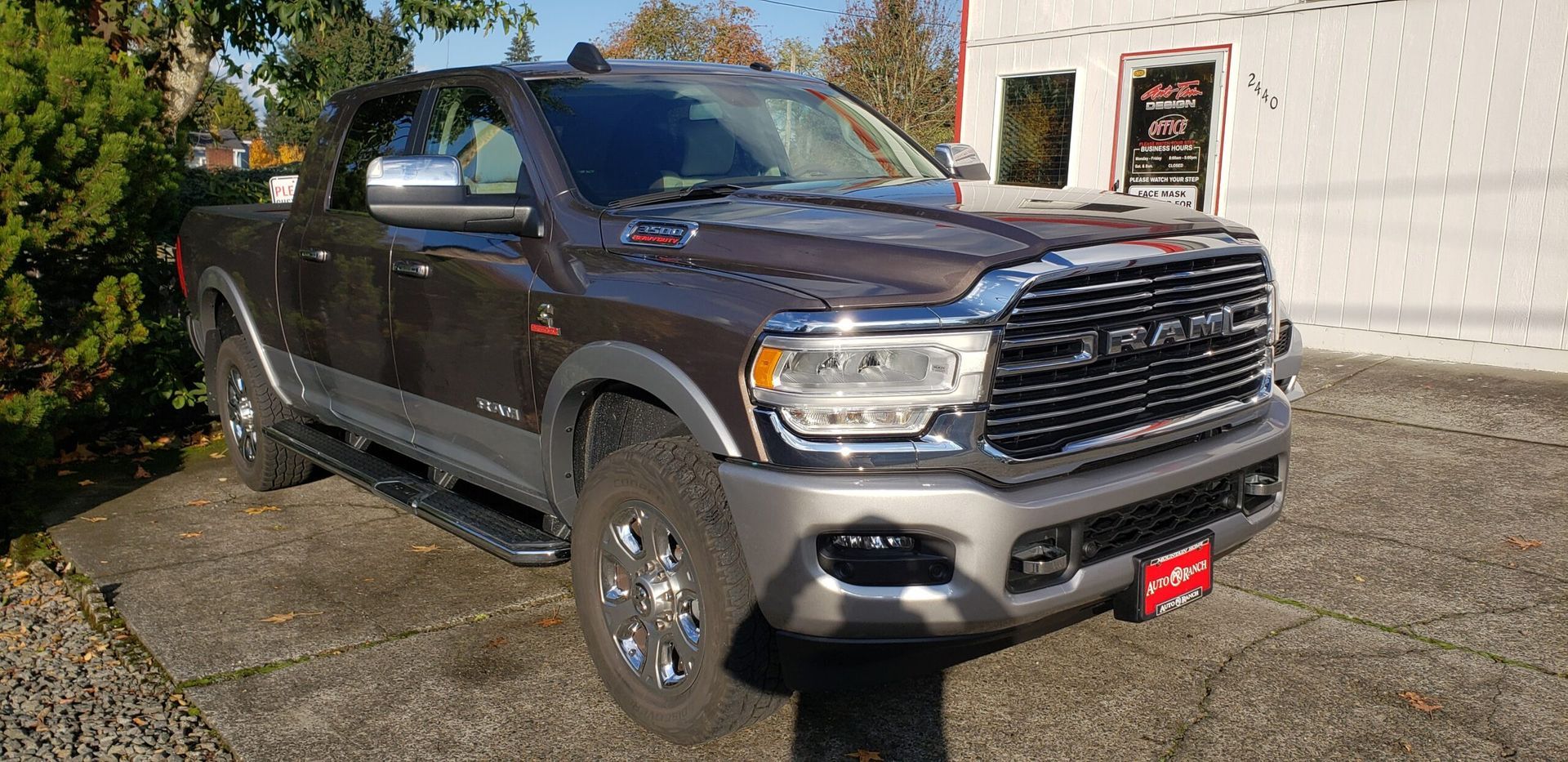 Dark gray RAM pickup truck parked outside a building on a sunny day