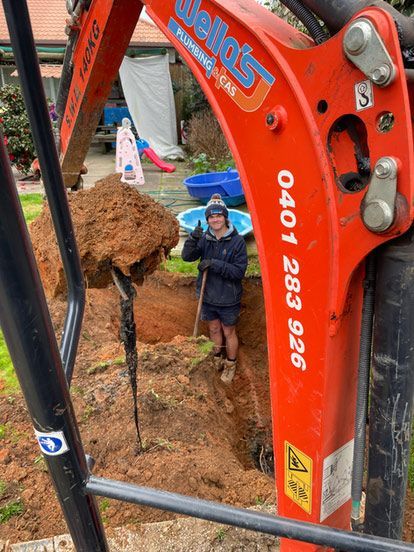 Two Men Are Working on a Fence in a Park — Wello's Plumbing & Gas In Thurgoona, NSW