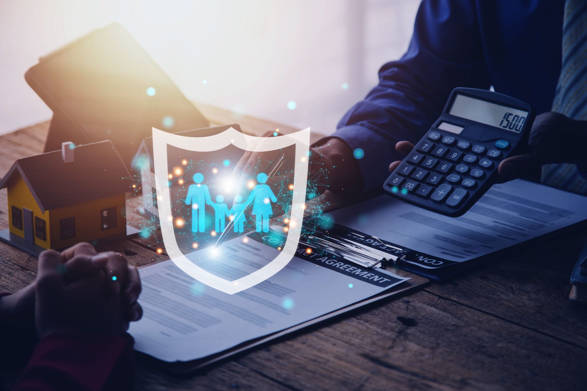 Cybersecurity workspace with laptop, glowing shield icon, and calculator on a desk
