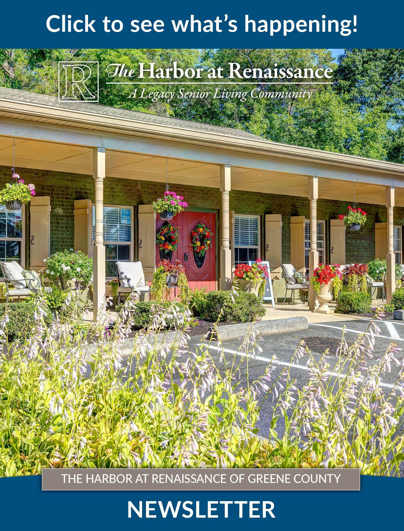 A house with a porch and flowers in front of it