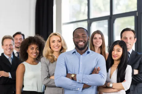 A group of business people are posing for a picture together.