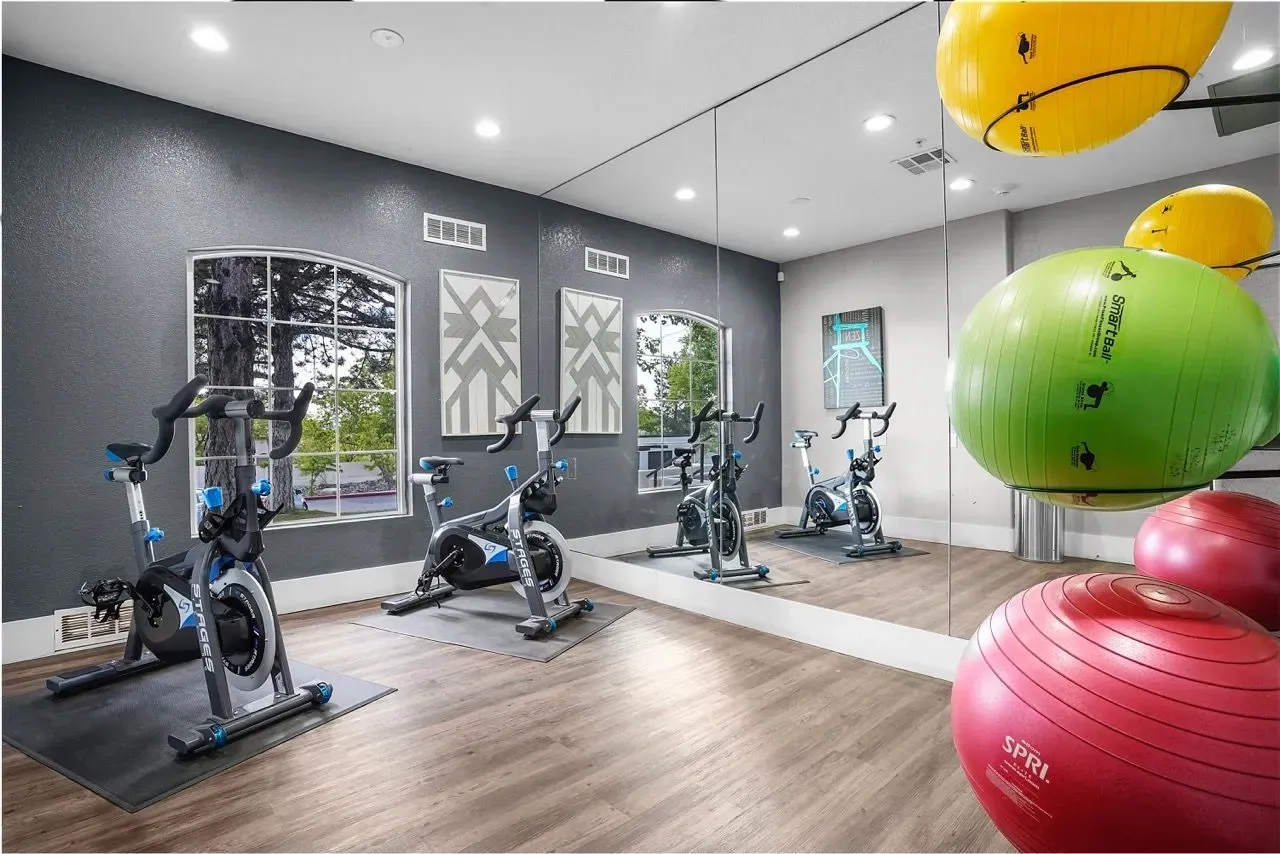 Spin bikes and exercise balls in a well-lit fitness center at La Ventana, offering apartments in Albuquerque, NM.