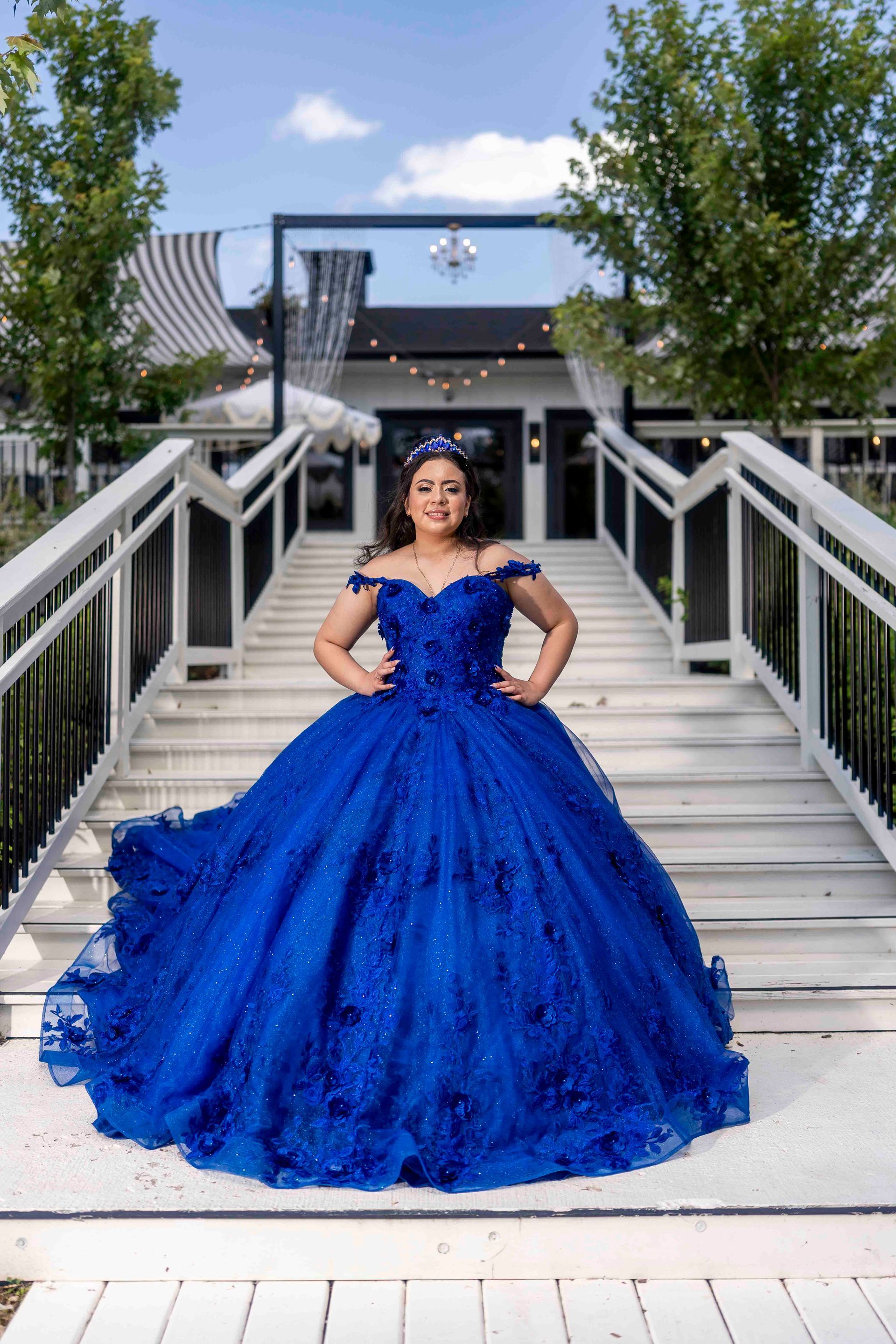 Celebrant posing for her Quinceanera photos outside on the patio