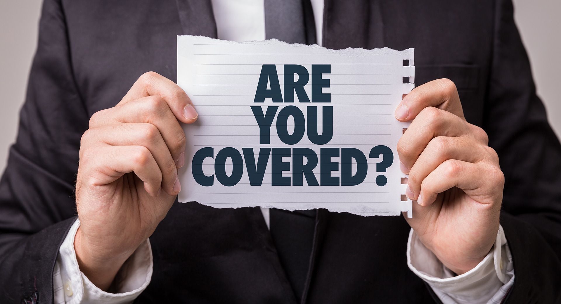 Person Holding Are You Covered Sign