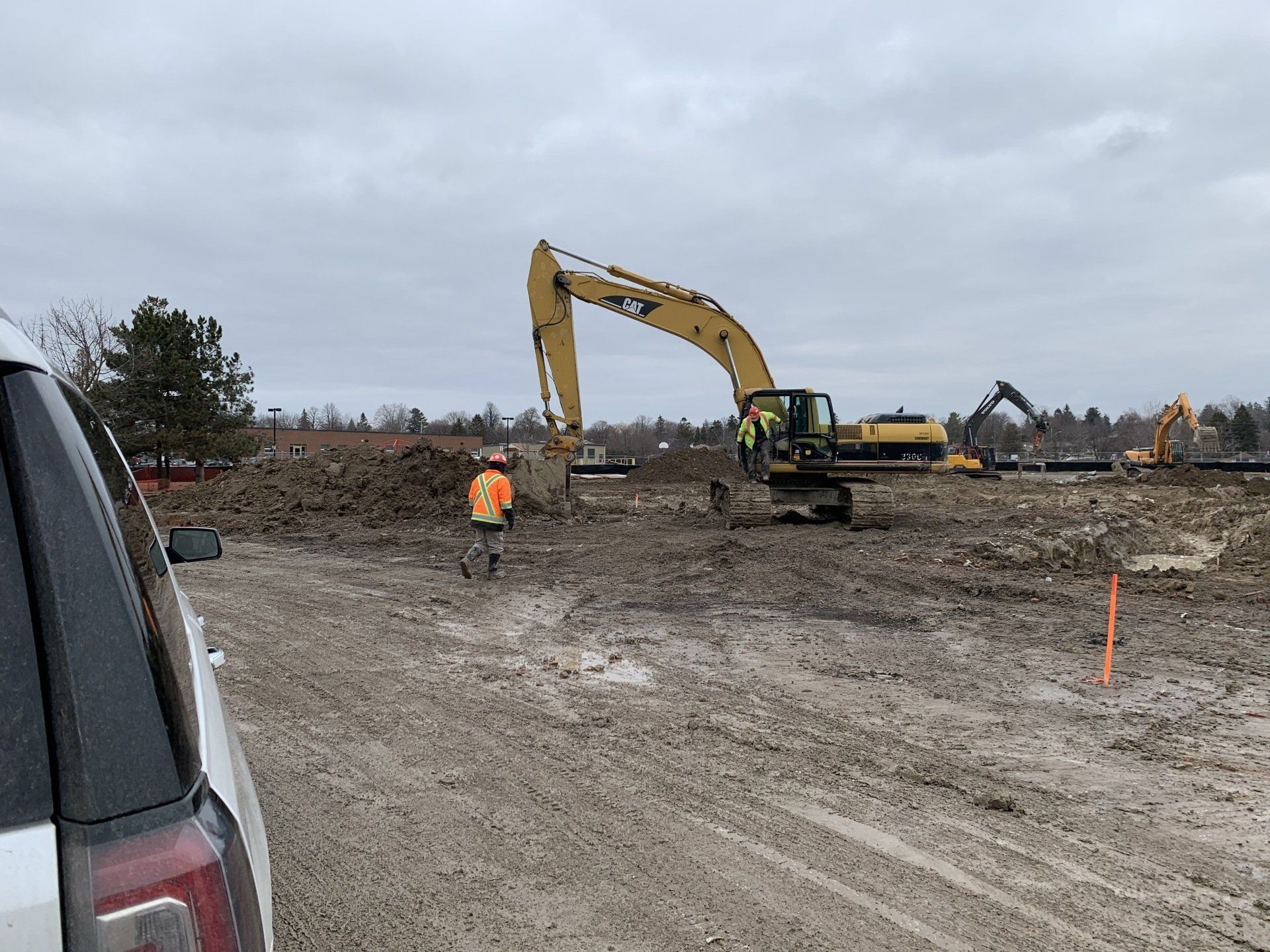 A construction site with a large excavator in the middle of it.