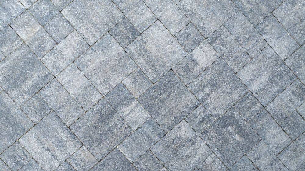 Gray stone pavement with a diagonal pattern of rectangular tiles