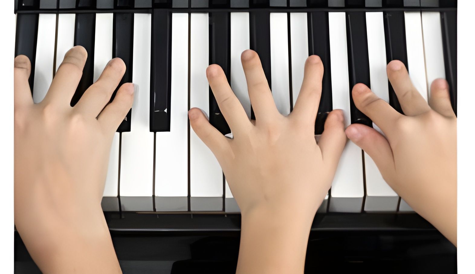 Three hands playing black and white piano keys from above