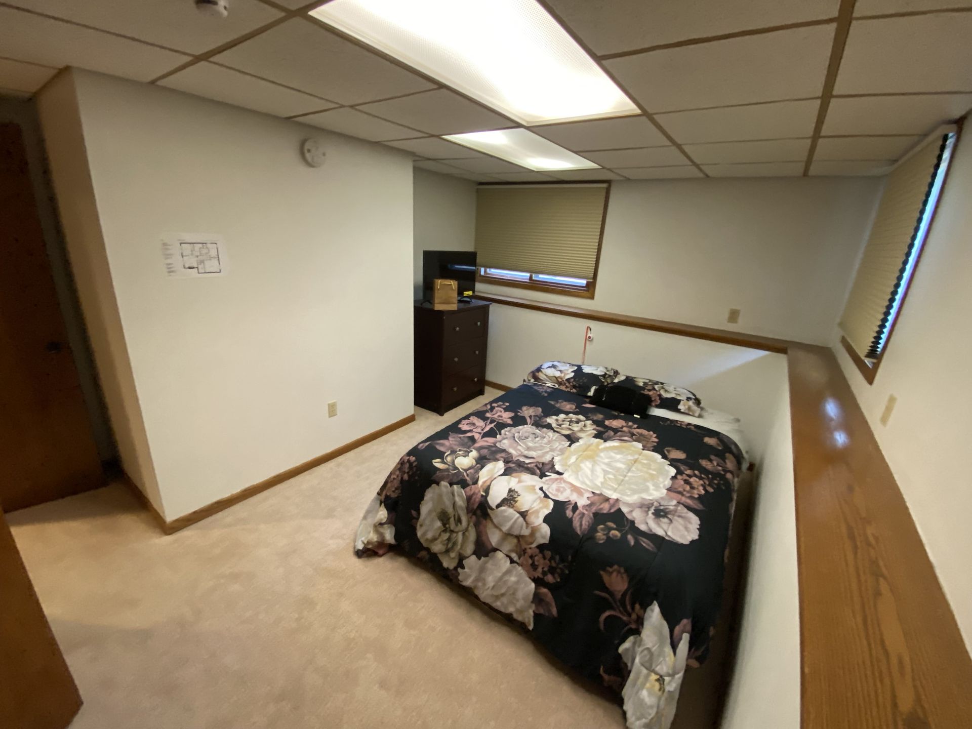 A bedroom with a bed and a window.