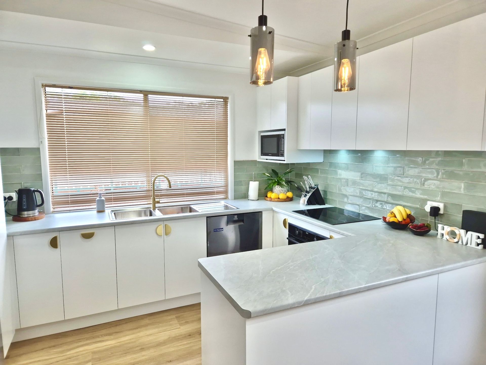 A kitchen area with light coloured green tiles around walls — Seeto Tiling in Fingal Bay, NSW