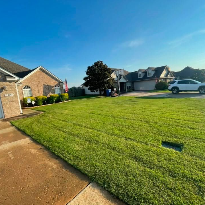 Suburban neighborhood lawn with edged and trimmed grass along driveway