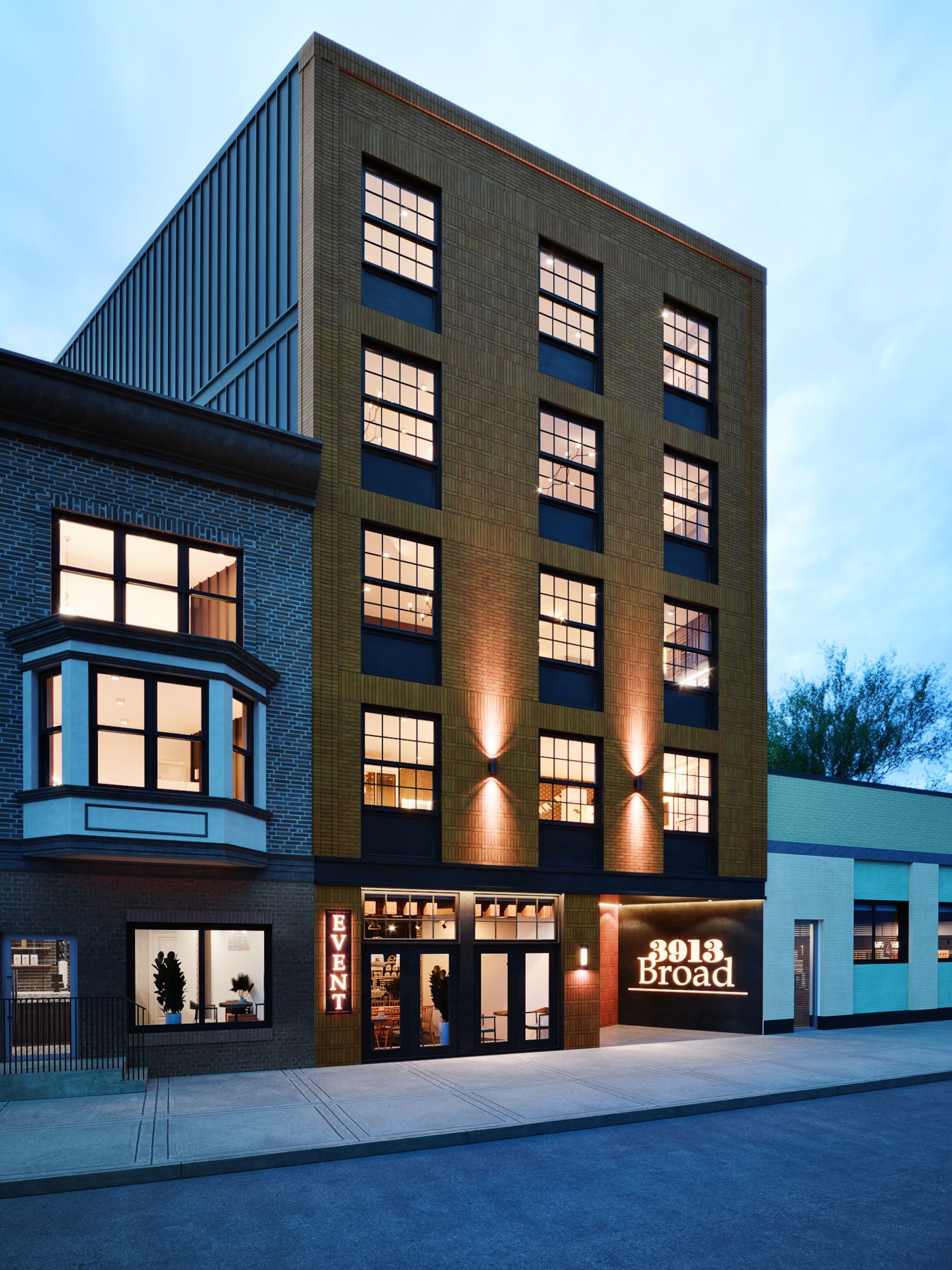 A large brick building with lots of windows is lit up at night