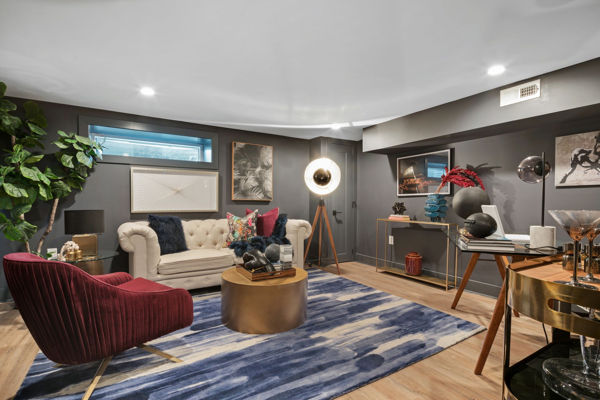 A living room with a couch , chair , table and rug.