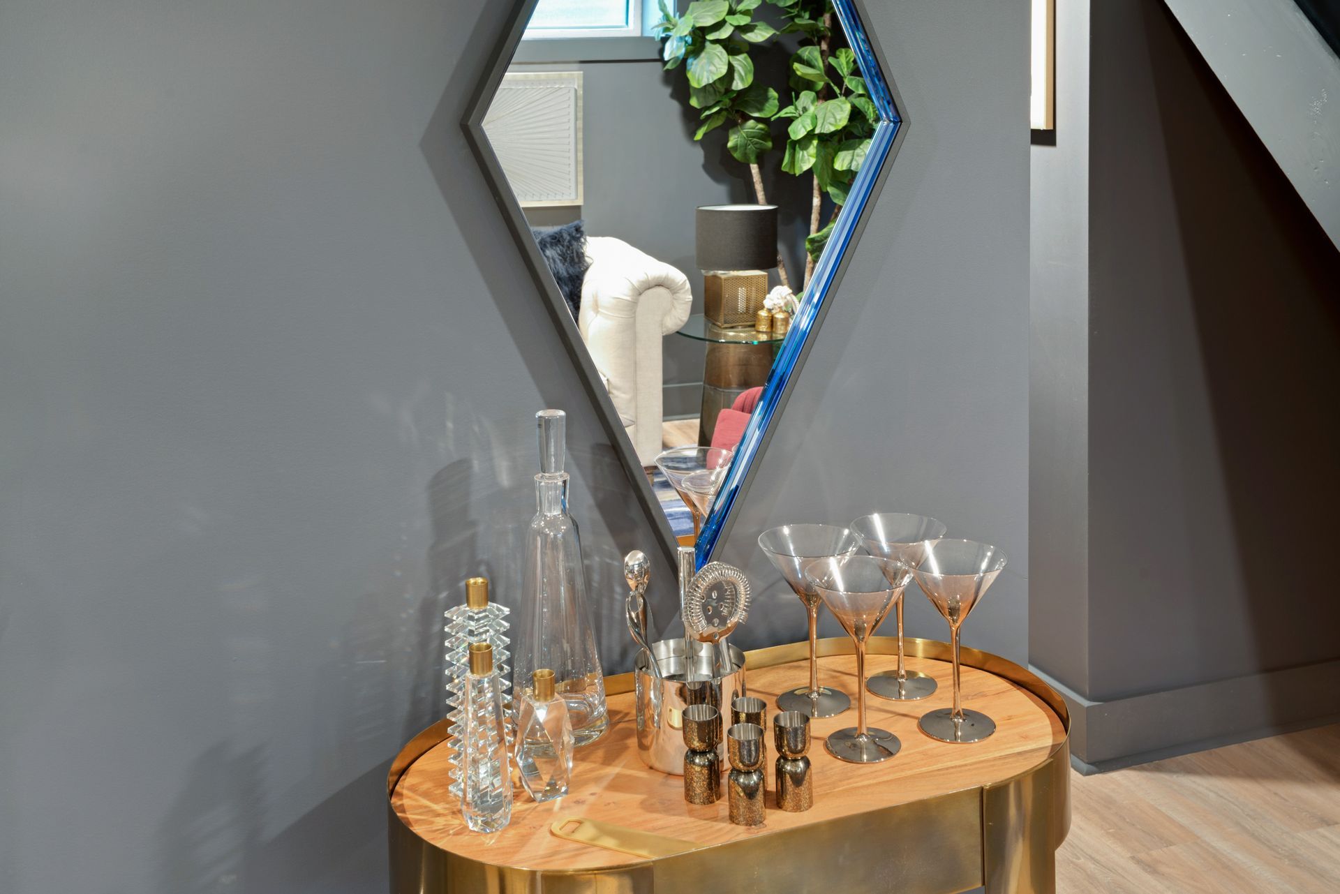 A table with a mirror and glasses on it in a living room.