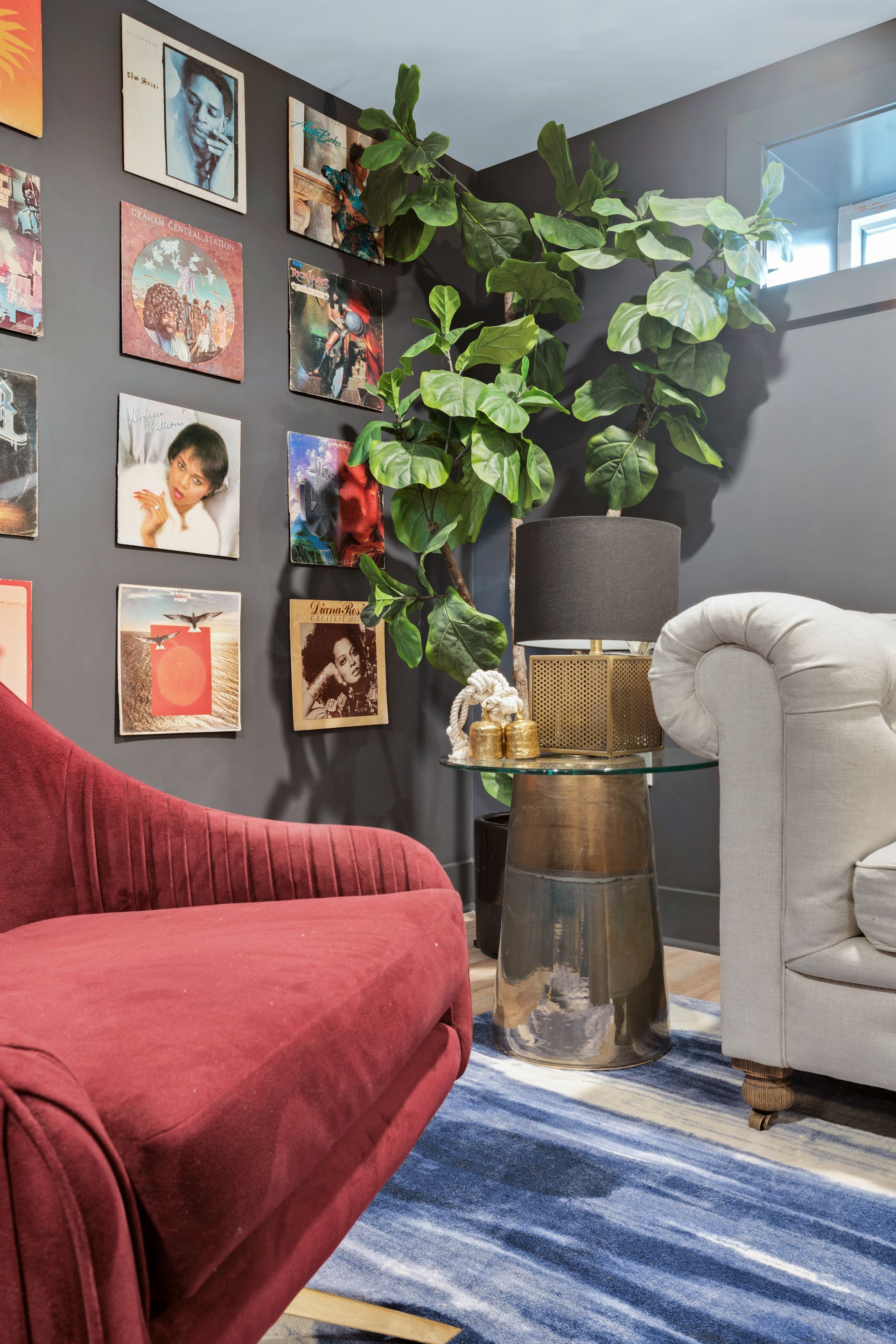 A living room with a red chair and a white couch.