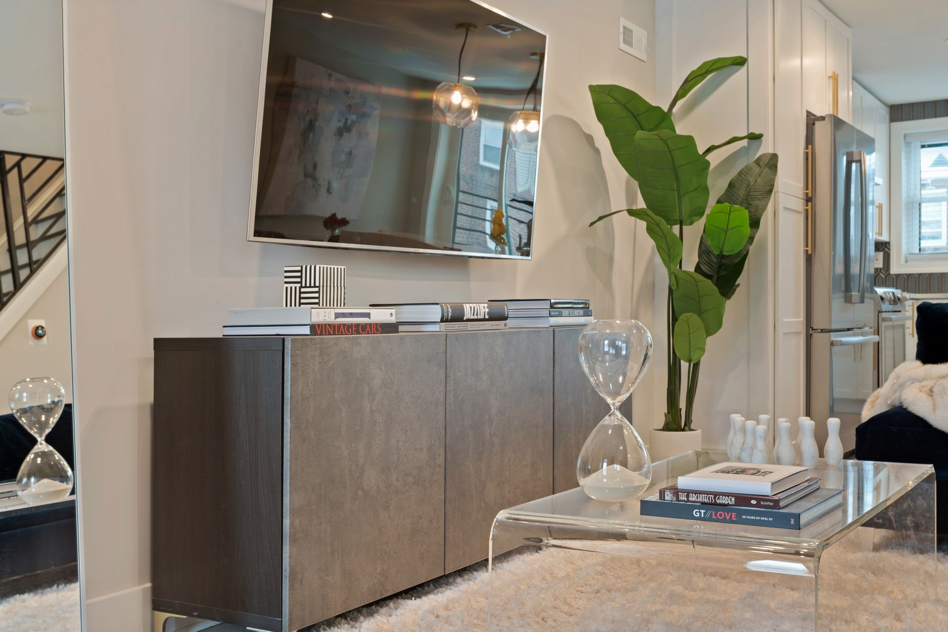 A living room with a large flat screen tv on the wall
