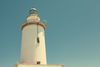 White lighthouse against a clear blue sky