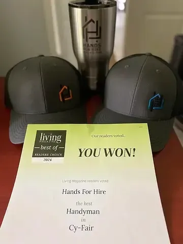 Two hats and a tumbler with a company logo. A 