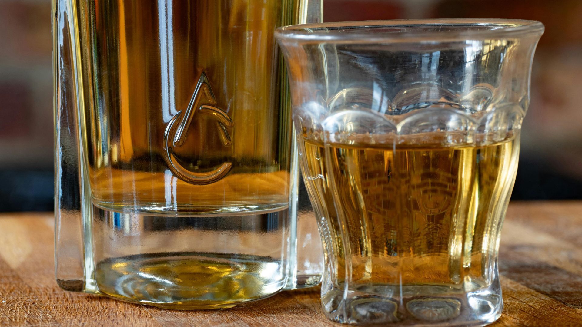 A clear glass decanter embossed with a