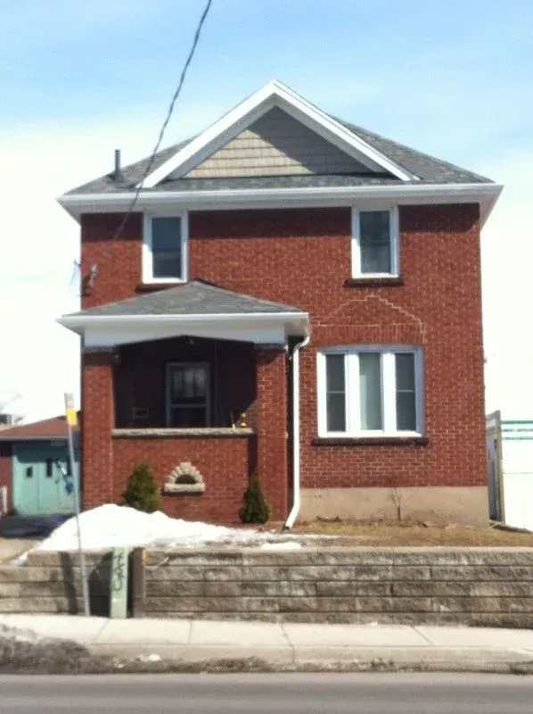 A large red brick house with a gray roof