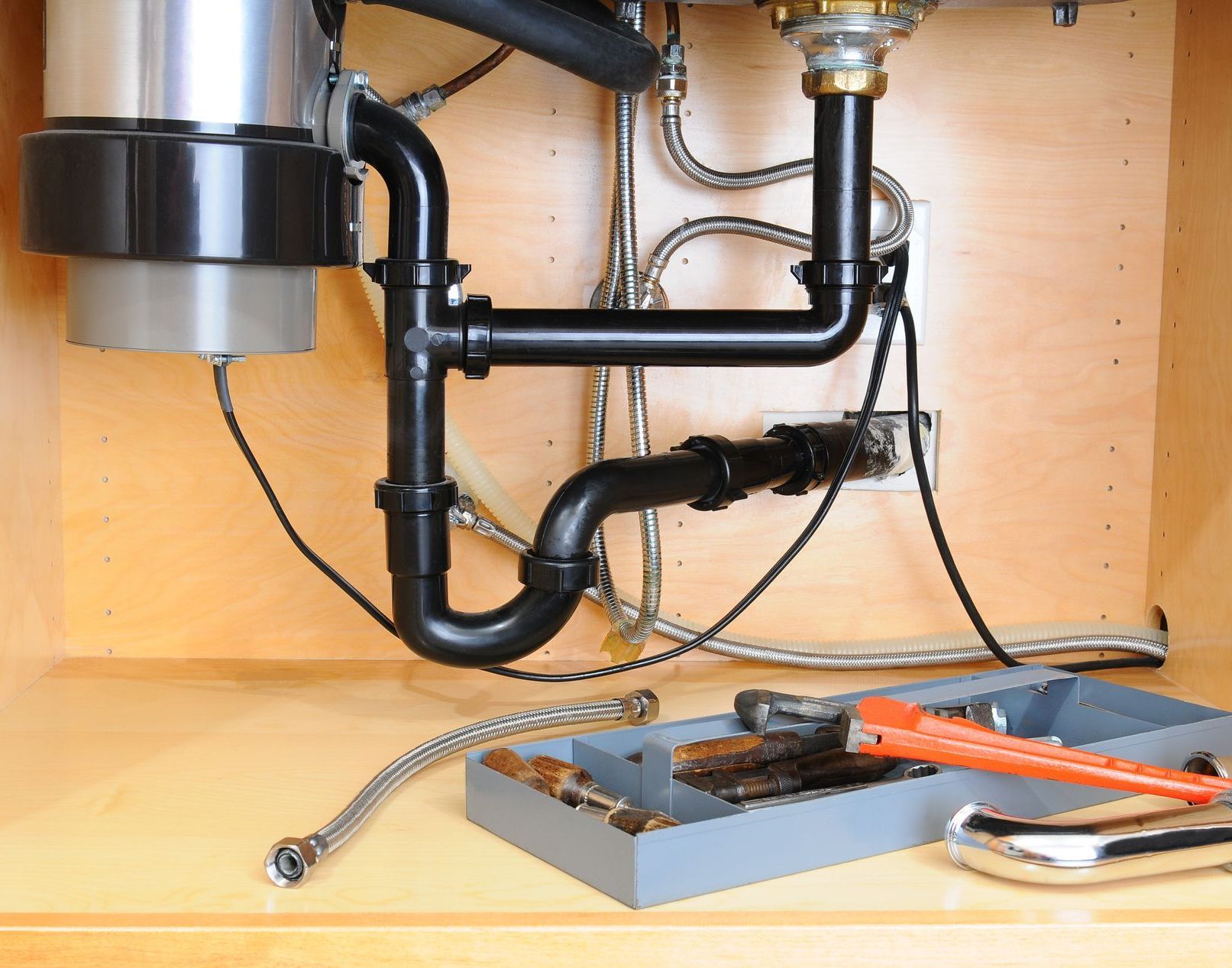 A compact garbage disposal unit installed beneath the kitchen sink