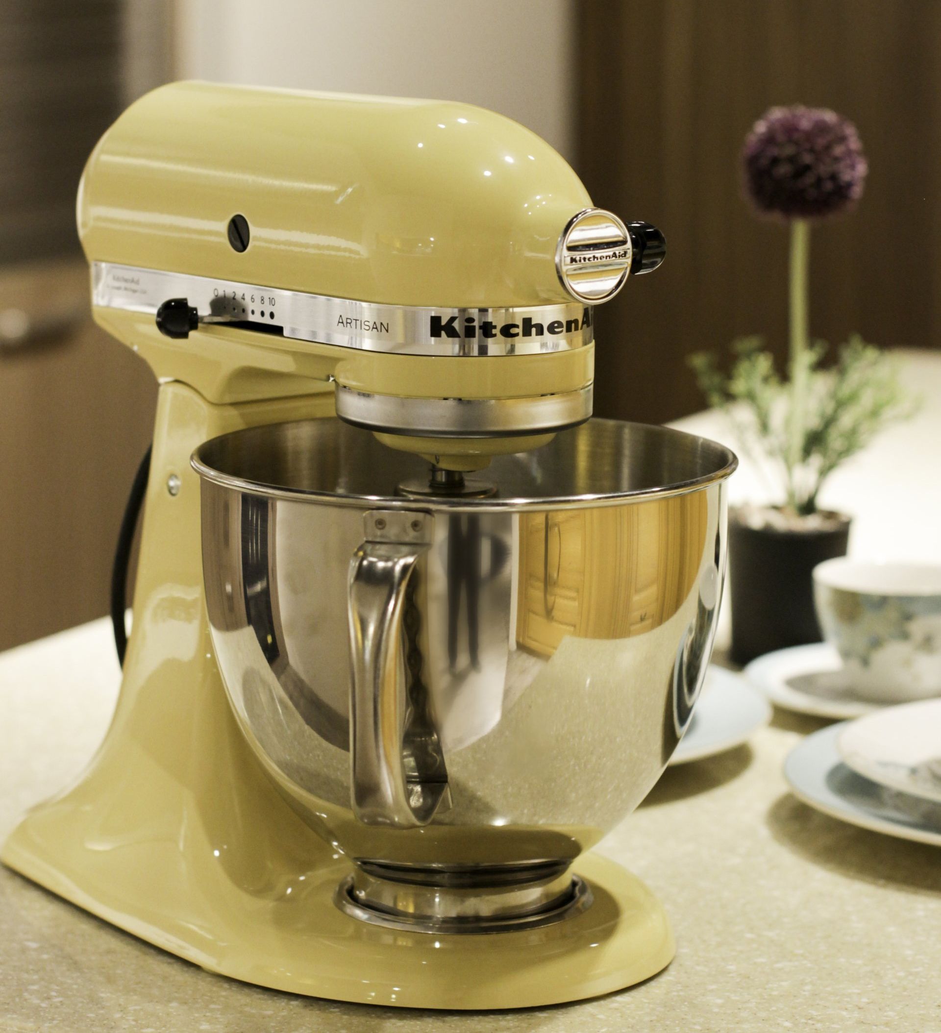 Image of a yellow KitchenAid stand mixer on a kitchen countertop, ready for culinary adventures.