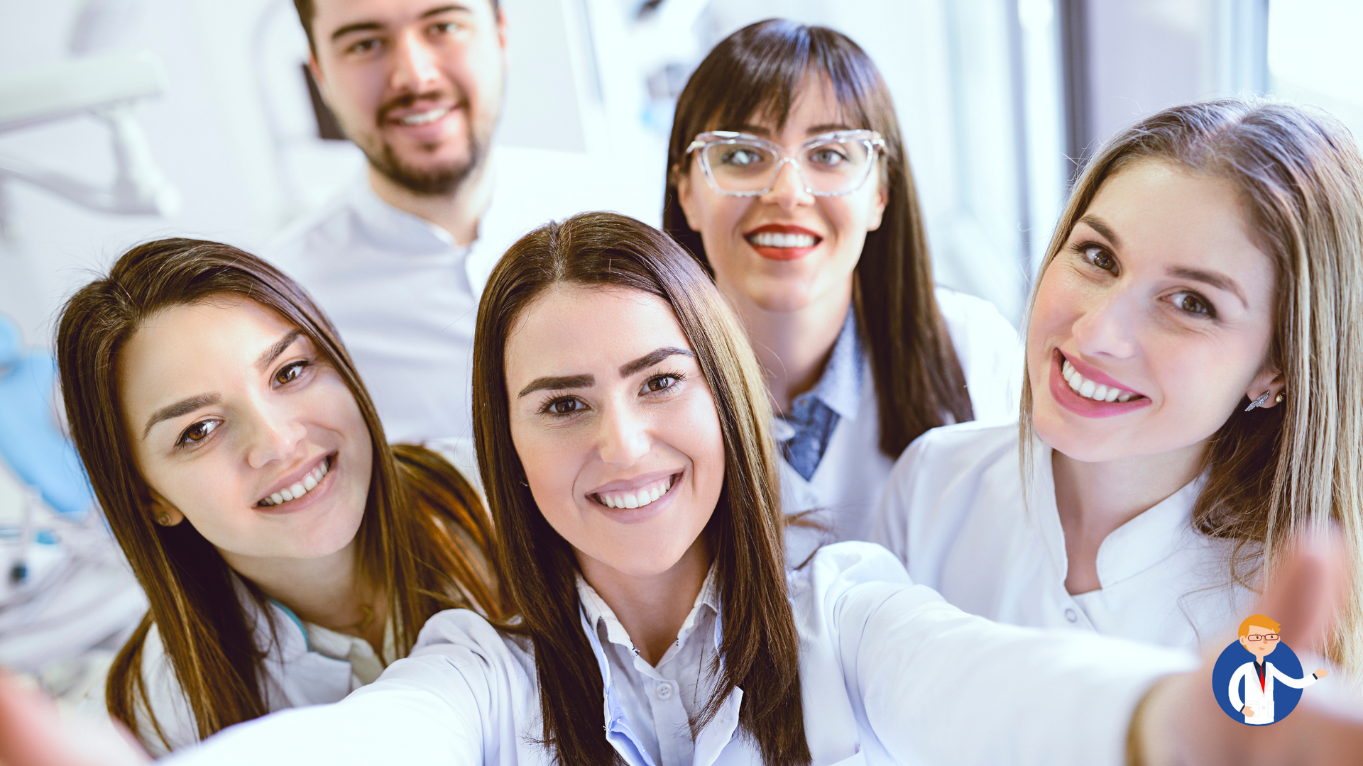 A group of dentists are taking a selfie together in a dental office.