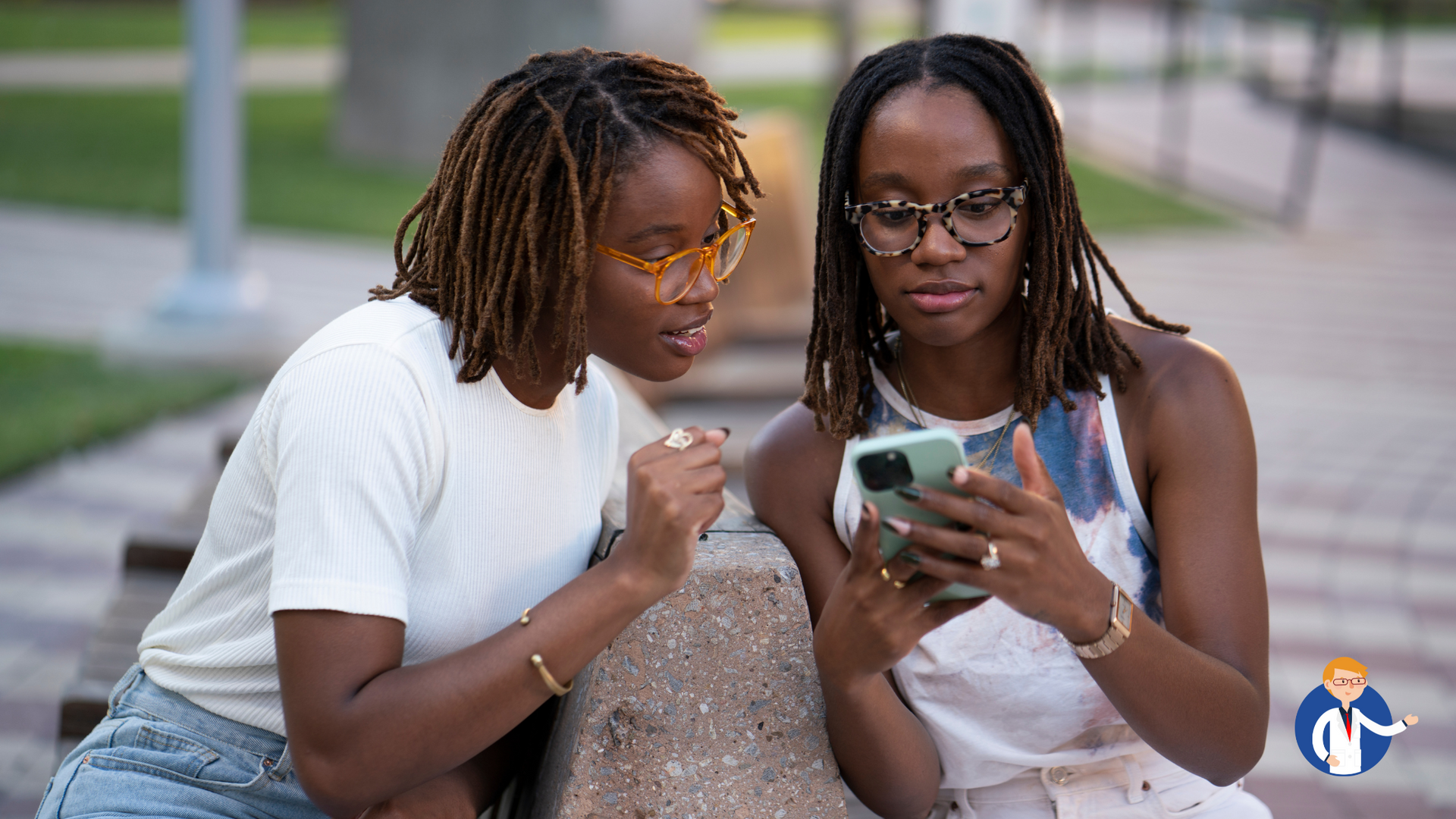 Two women are sitting on a bench looking at a cell phone.
