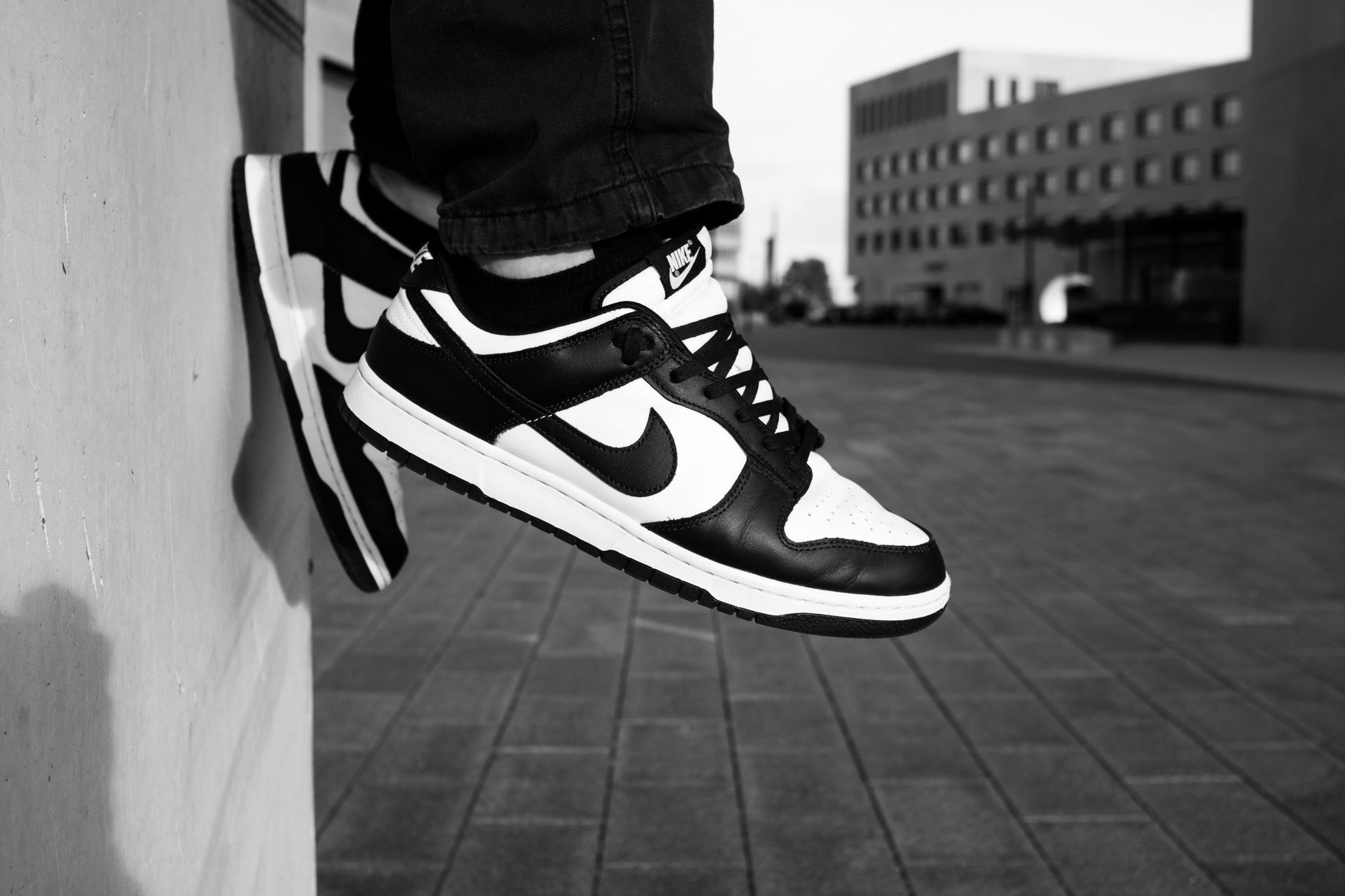A pair of Panda Dunks on the pavement