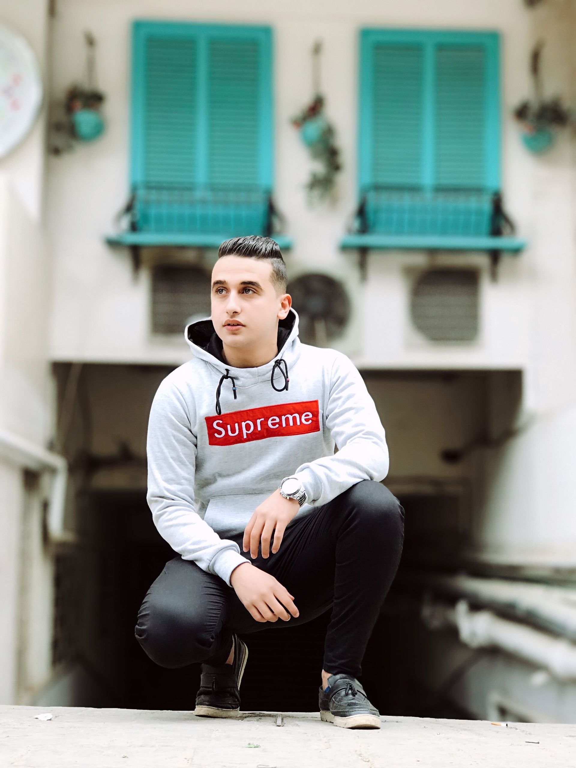 A shopper in a Supreme hoodie out on the street