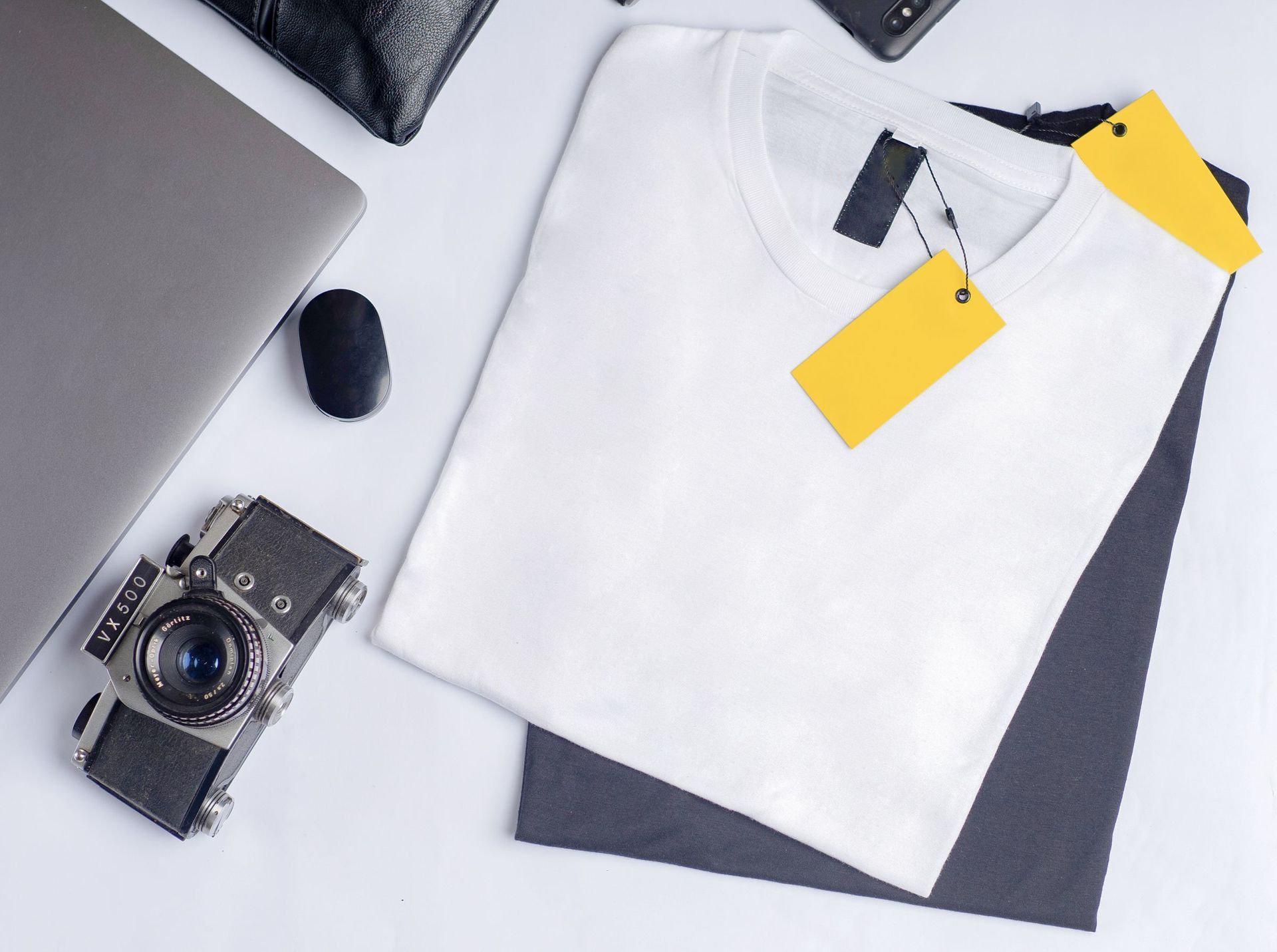 A tee laid out flat with its tag still on it