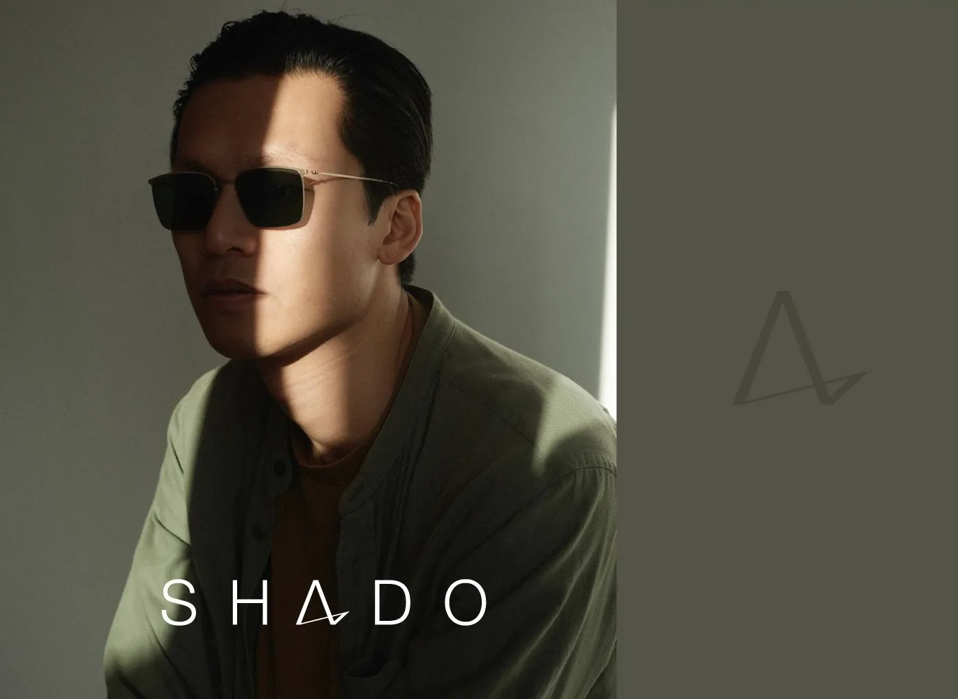 Man wearing sunglasses, bathed in sunlight.
