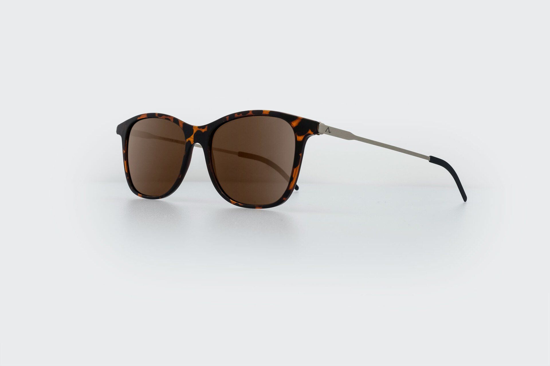 Sunglasses with brown lenses and tortoiseshell frames, silver arms.