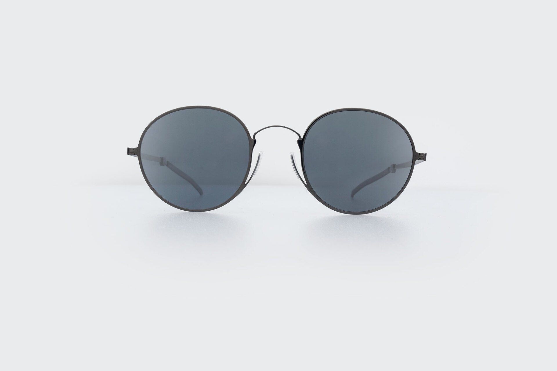 Round black sunglasses on a white background.