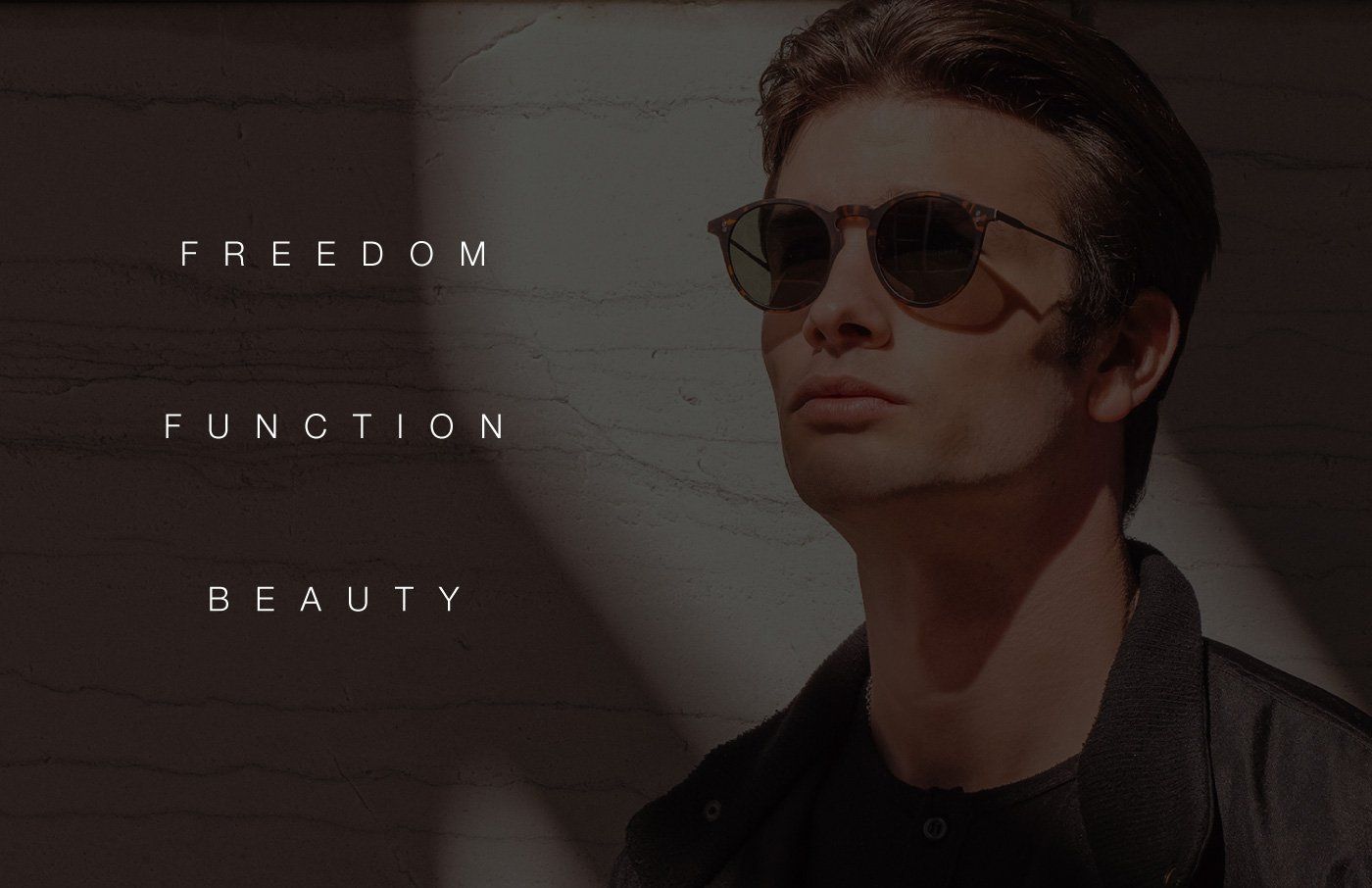 Man wearing sunglasses, leaning against a wall with text reading