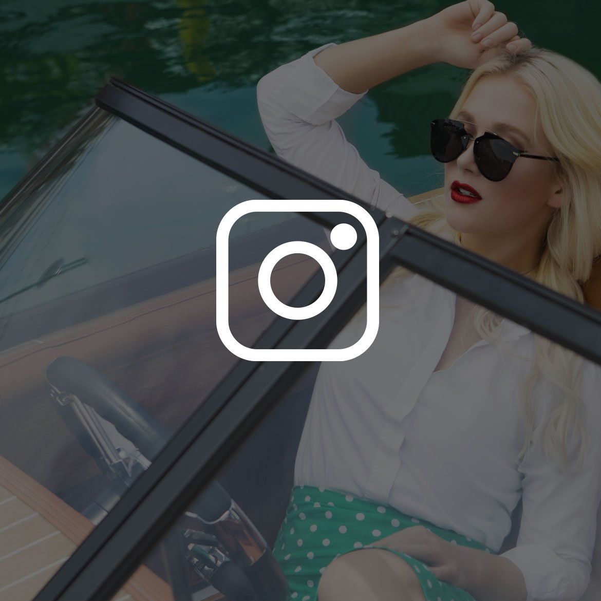 Blonde woman on a boat, wearing sunglasses, white shirt, and a green polka dot skirt.