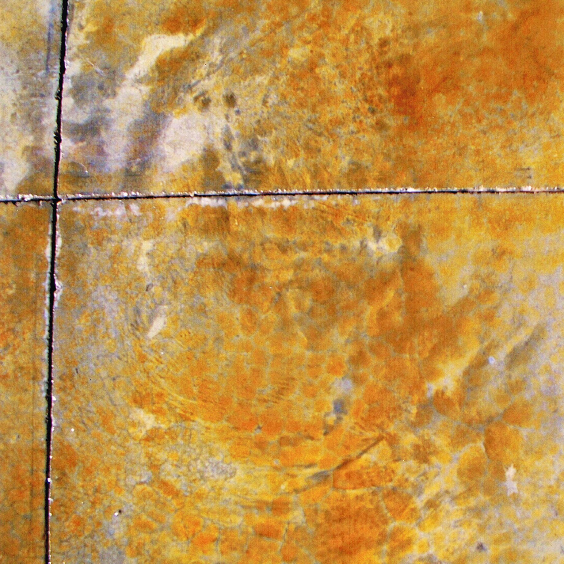 Close-up of an orange and gray marbled tiled surface with dark grout lines