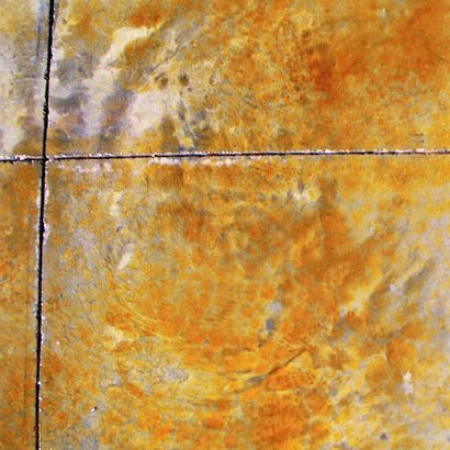 Orange and yellow textured tile with dark grout lines forming a cross pattern