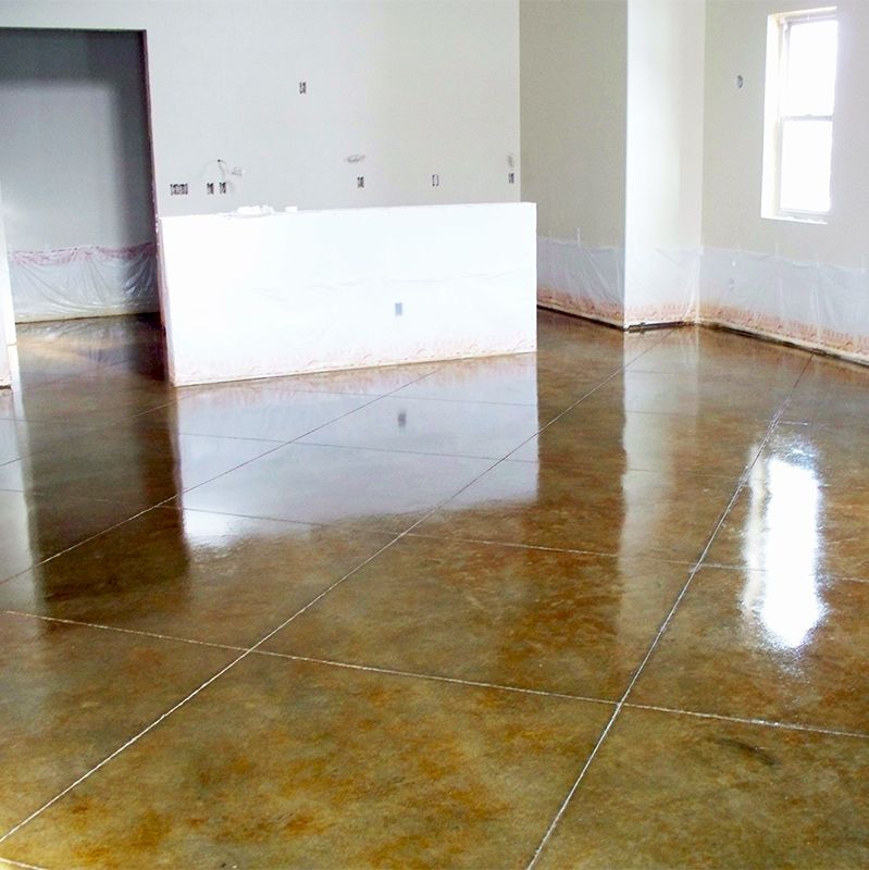 Empty room with glossy brown tiled floor, white walls, and bright windows