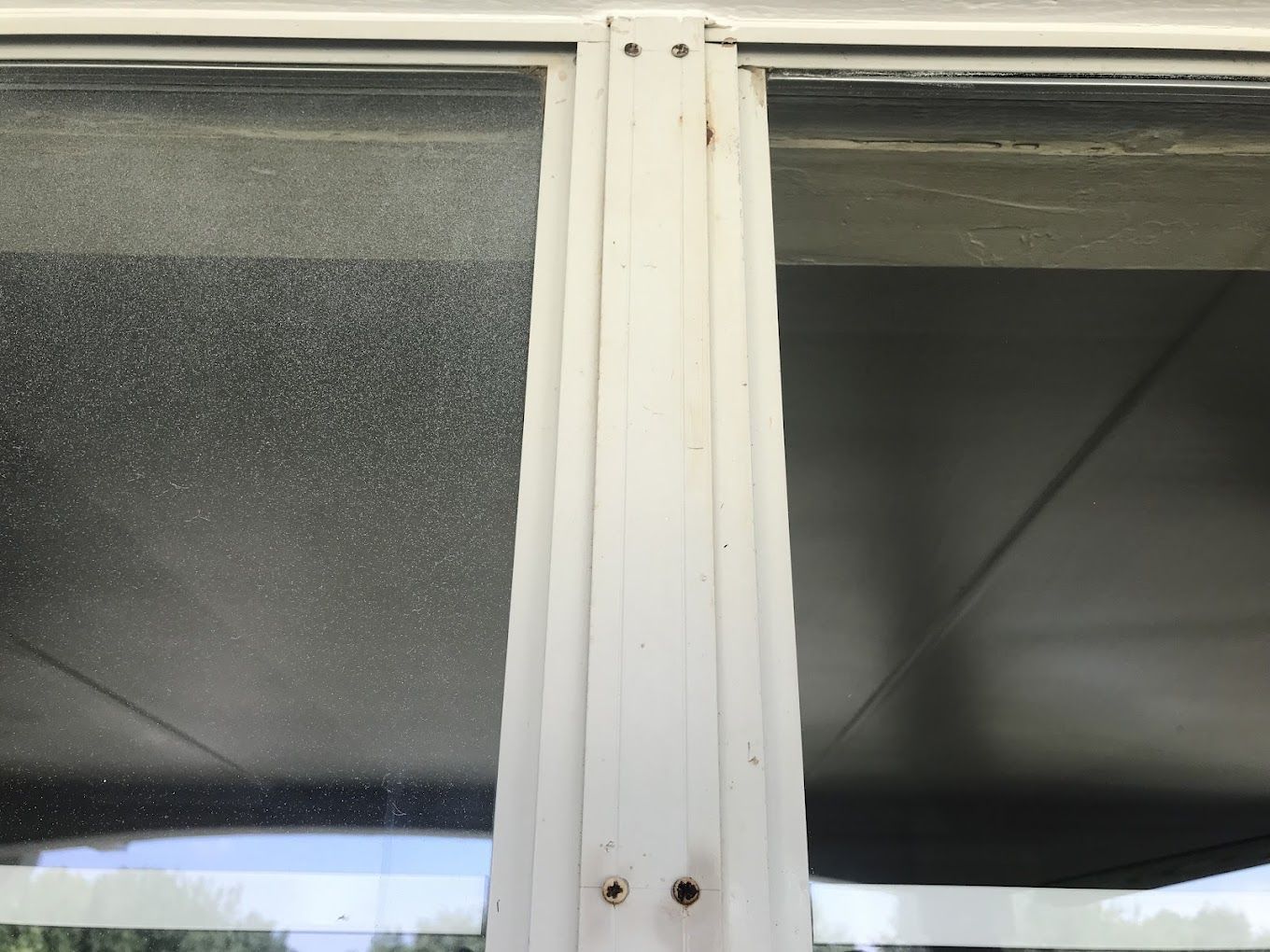 A close up of a window with a white frame