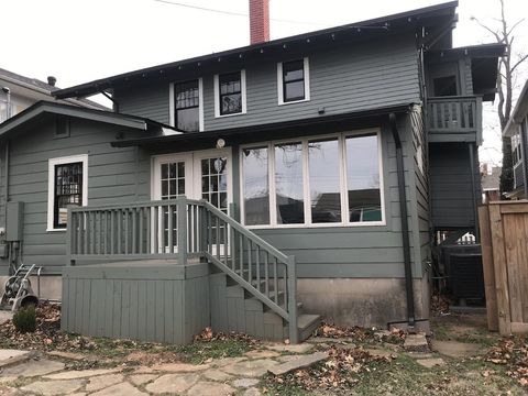 The back of a house with a deck and stairs.