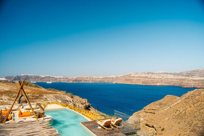 Azure pool overlooking caldera in Santorini.