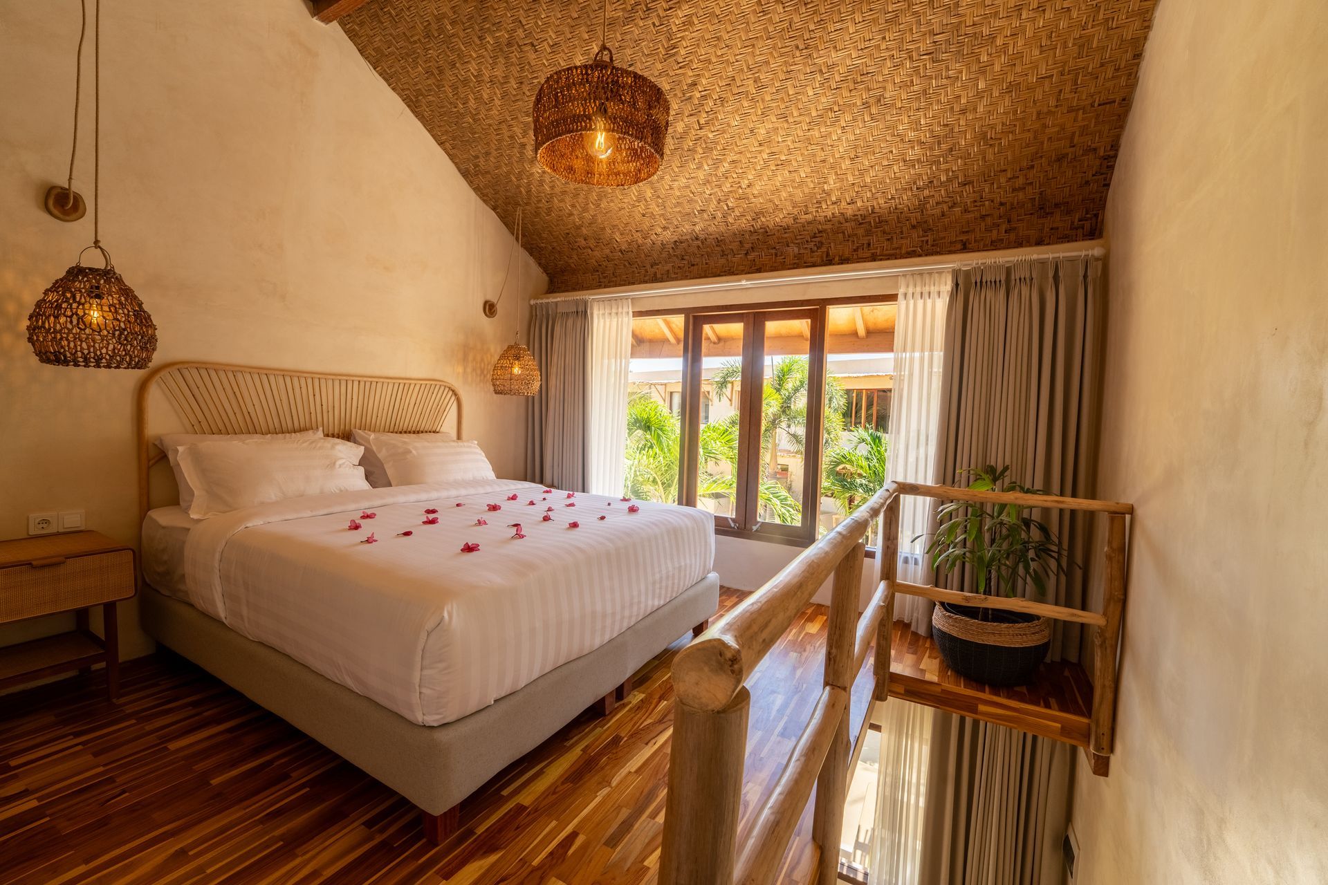 Bedroom with bed, wooden railing, window, and woven ceiling.