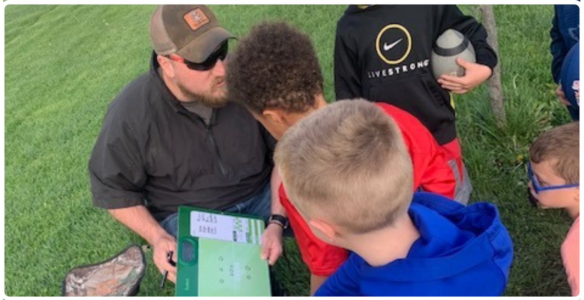 youth volunteer coach with young campers