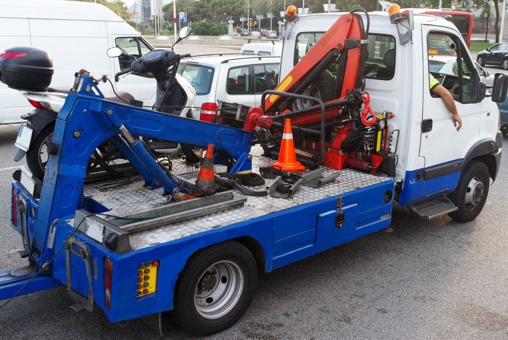 A Blue And White Tow Truck With A Motorcycle On The Back — Wilson's Towing In Pittsworth, QLD